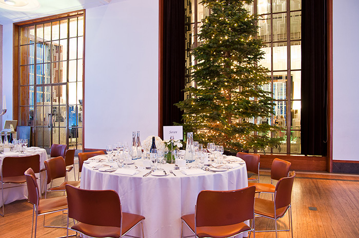 Christmas tree stands with tables set for dinner