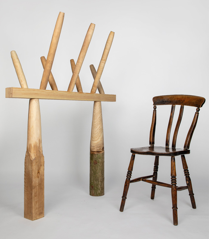 Wooden structure model next to traditional wooden chair with grey backgroundjpg