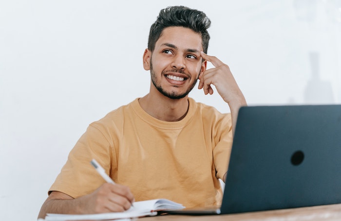 Architect sits sthinking at a laptop as he works in an office LARGEjpg