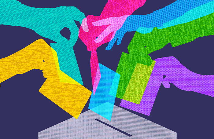 Colourful graphic of hands putting votes in an election box 700jpg