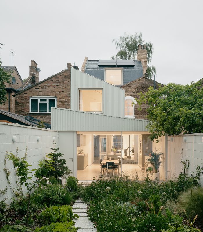 Deep pitched white house extension overlooking gardenjpg