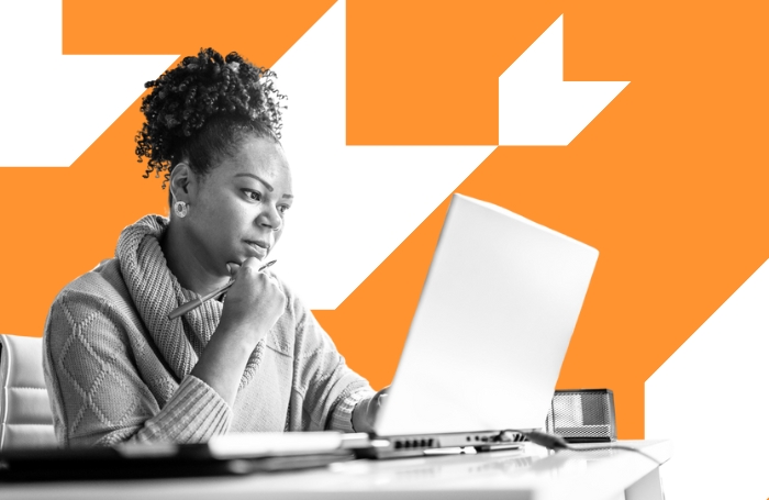 Female architect sitting behind a desk reading her laptop GC LARGEjpg
