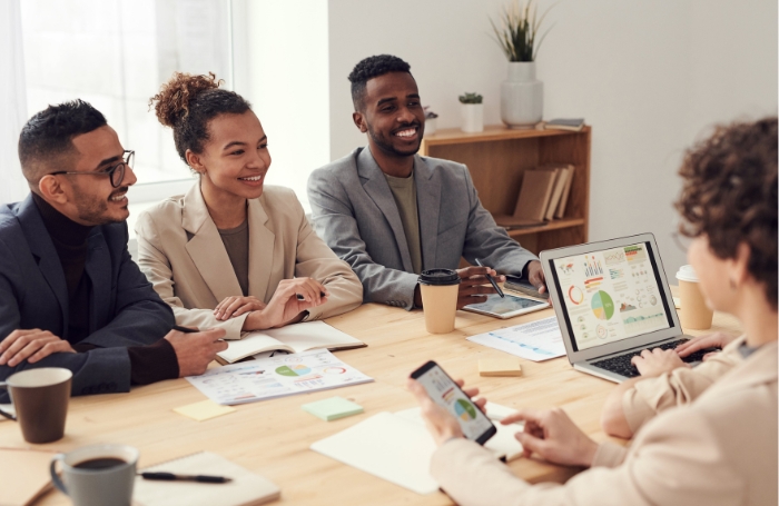 Group of professional people sitting at a desk in discussion LARGEjpg