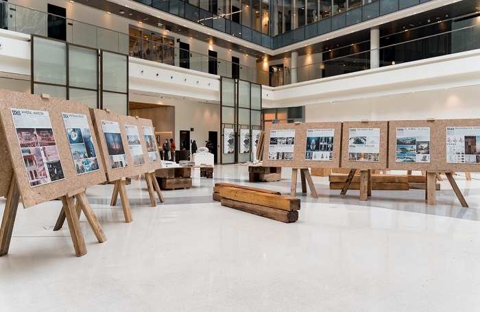 Gulf chapter exhibition d3700x455jpg Selection of art on easels in large open space with concrete floor.