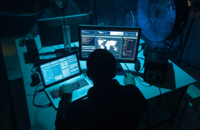 Hackers coding virus ransomware using laptops and computers 700455jpg
