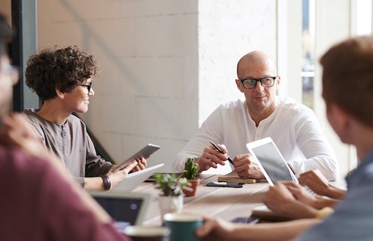 Man addressing a team of people in an office LARGEjpg