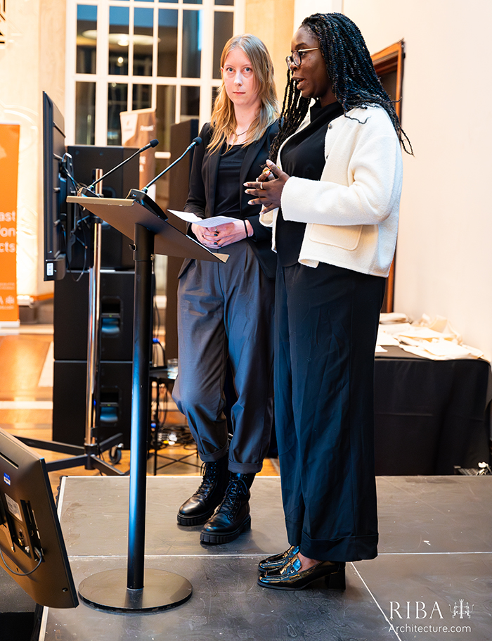 RIBAStudentAwardCeremony2024Studentwinnersspeakingjpg Two students who won at the RIBA London Student Awards at a podium speaking