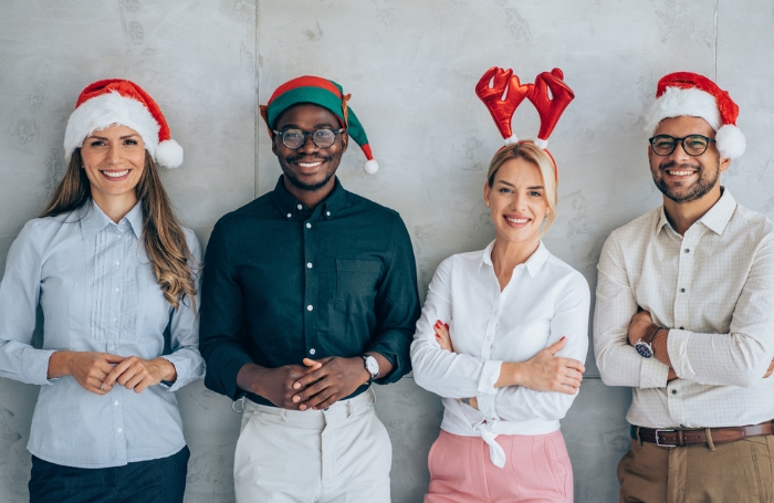 Two men and two women looking to camera and smiling wearing Christmas heasdware GC LARGEjpg