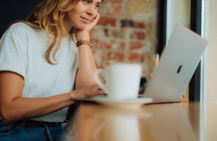 Woman looking at her laptop in a cafe LARGEjpg