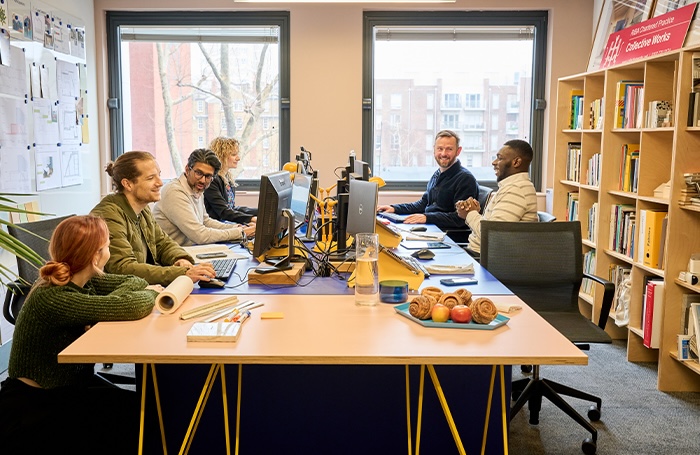 architects sitting around a desk with computers in their London office EDI toolkit 1jpeg People chatting in an office space