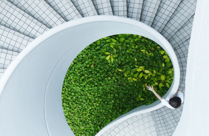 woman standing at top of spiral stairsbody700x455jpg