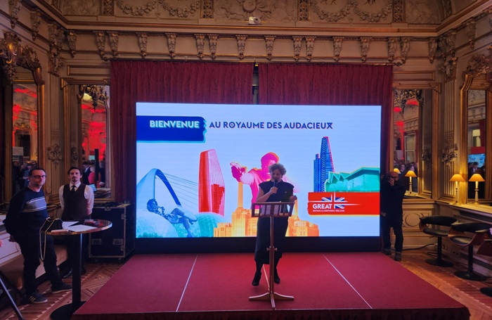 Dame Menna Rawlings 700x455jpg Dame Menna Rawlings presenting on a stage in front of a screen