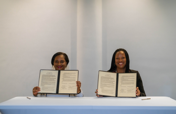 Dr Valerie VaughanDick and Lakisha Ann Woods signing RIBA and AIA MOU 700x455png