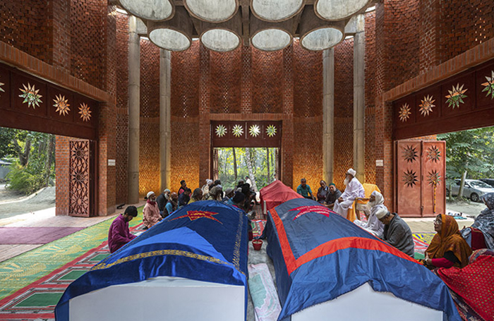 Inside Shah Muhammad Mohsin Khan Mausoleum with people and casketsjpg