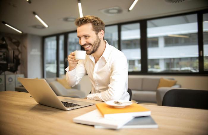 Man working in an office drinking coffeejpg