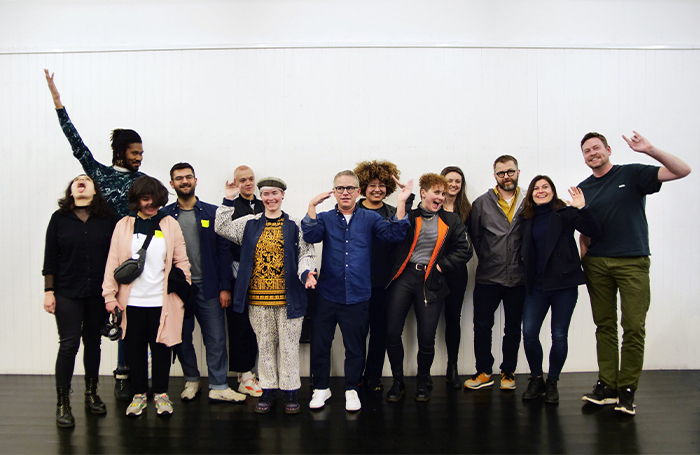 Queerspace team group members in front of a white walljpg