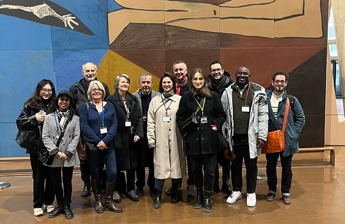 RIBA Europe Group tour Unesco 455jpg Twelve people standing in a group facing camera in front of Picasso mural