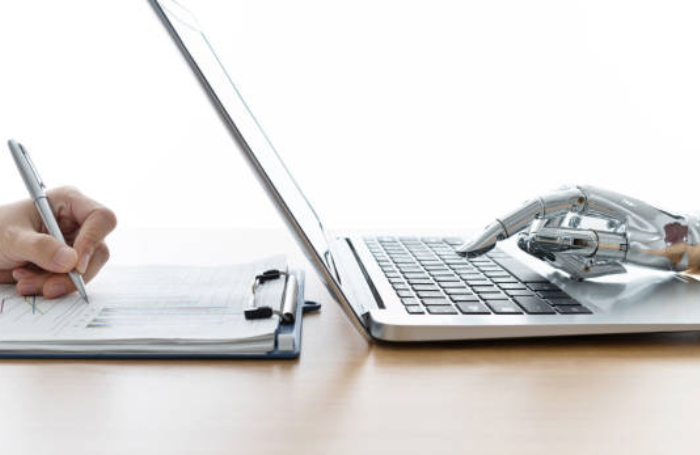 Robot hand using laptop and man hand writingpng
