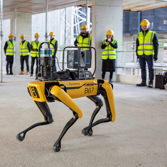 Yellow robotic dog with construction workers in backgroundjpg