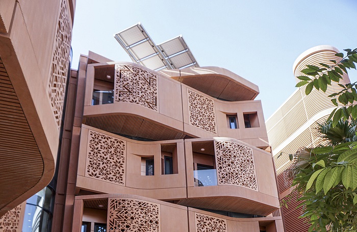 950x700MASDAR 1Jon Wallis700x455jpg Irregular shaped terracotta coloured recessed balconies with lasercut metal facades