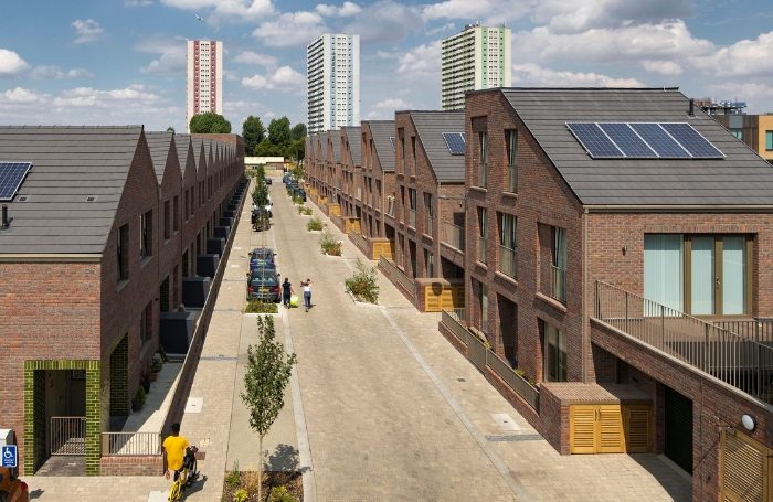 A row of newbuild social houses with cityscape in the background GC LARGEjpg