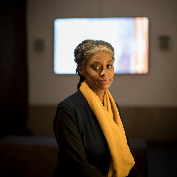 Esi Eshun infront of the Vanishment film screenjpg