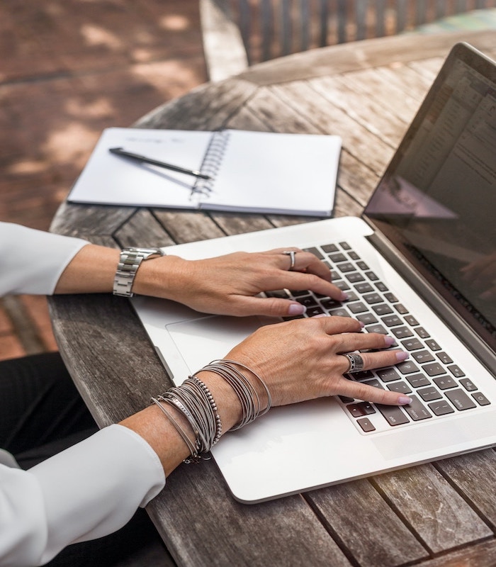 Female architect writing on her laptopjpg