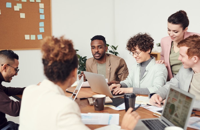 Group of people in an office discussing ideasjpg