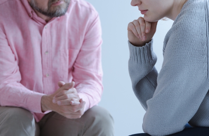 Man comforting a woman at work during bereavement GC LARGEjpg