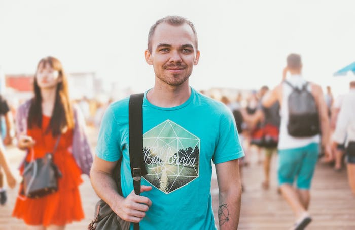 Man smiling to the camera and standing in the sunjpg