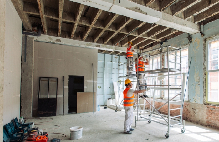 Men in hiviz and helmets working on an interior of an old building GC LARGEjpg