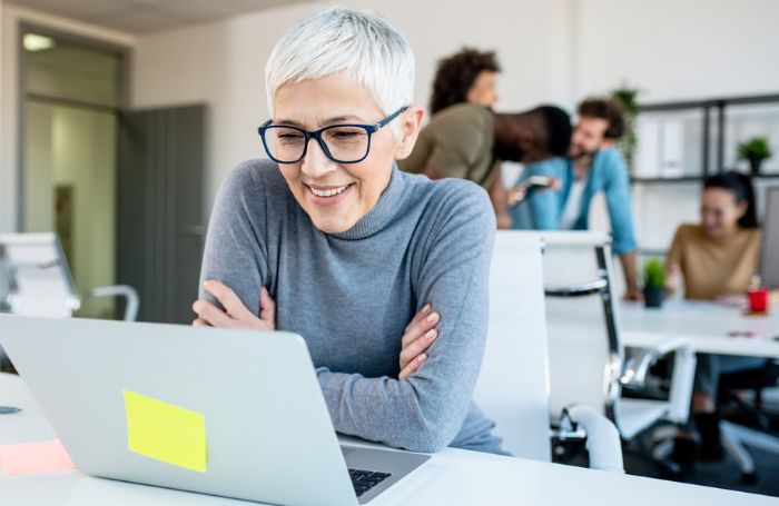 Middle aged woman looking at her laptop in her office LARGEjpg
