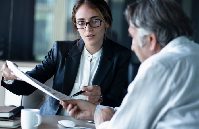 Person pointing at a document to a person 700455jpg