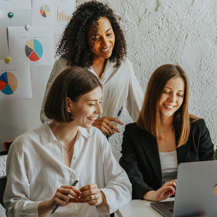 Three female architects working on a laptop700x700jpg