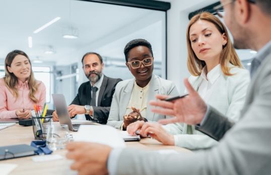 People discussing work in an office meeting