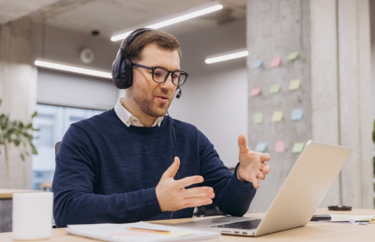 Professional Man speaking to another person via a headset